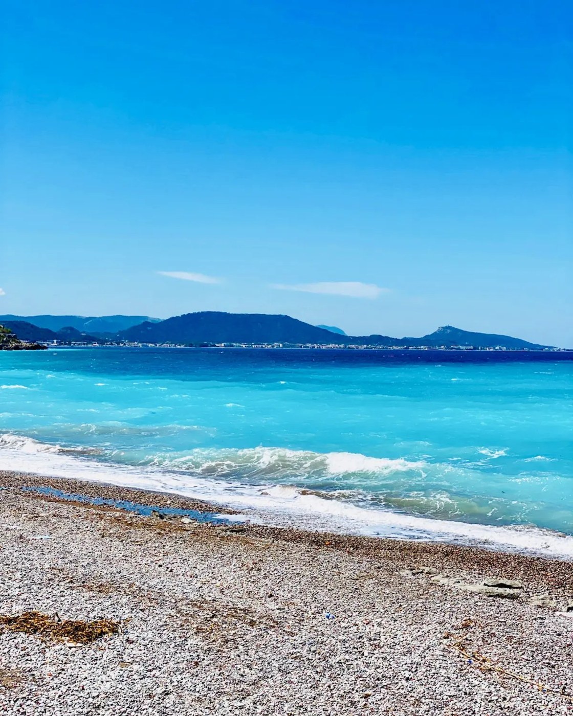 Beach and turquoise sea on the coast of Rhodes